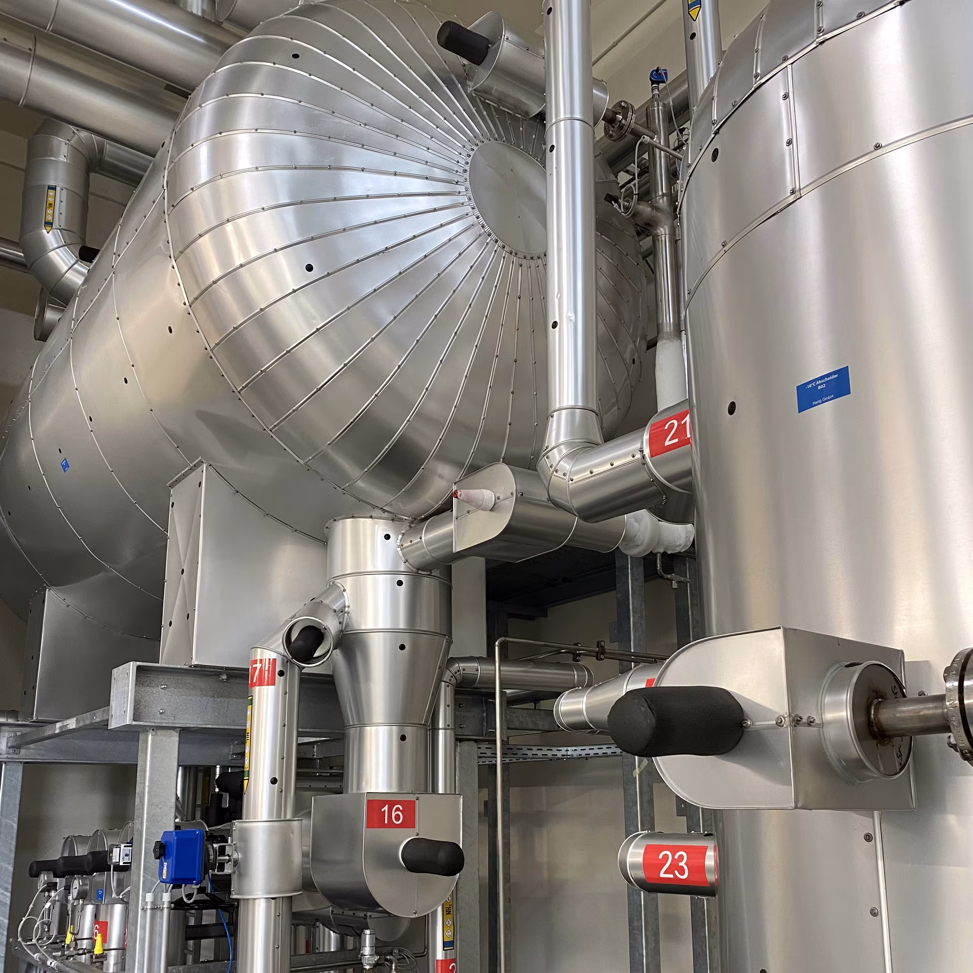 Modern PUR-foamed industrial installation with an insulated vessel and pipework
