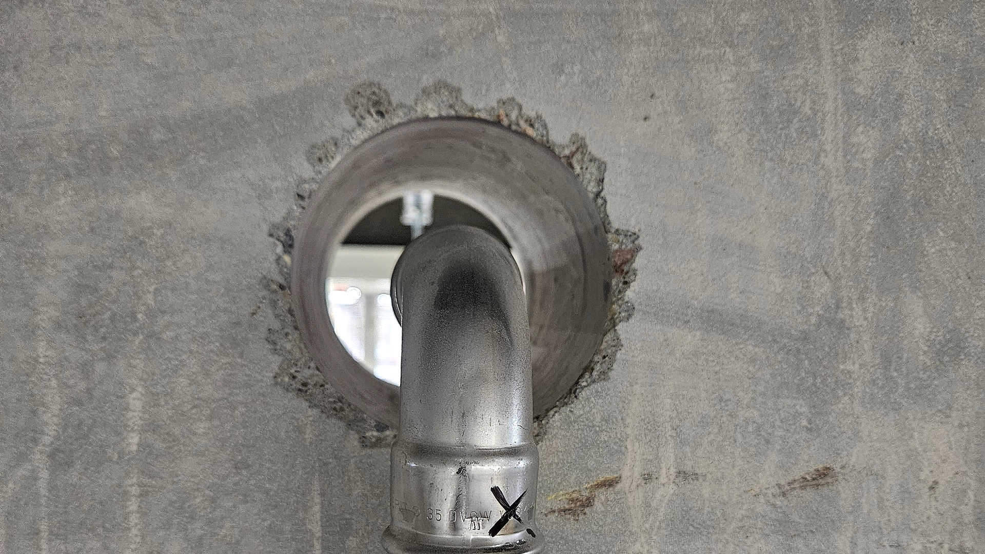 Open pipe penetration in fire wall 02 before the fire seal was installed at Sweet Tec
